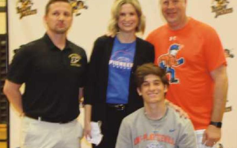 Luke Price will play soccer for the University of Wisconsin-Platteville, where he plans to major in engineering. Pictured with him are Coach Dennis Jeansonne and parents Brook and Dan.