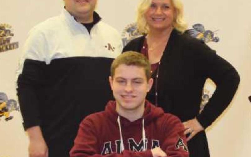 Seth Stahl will swim for Alma College where he will study history. Pictured with him are his parents Ryan and Brooke.