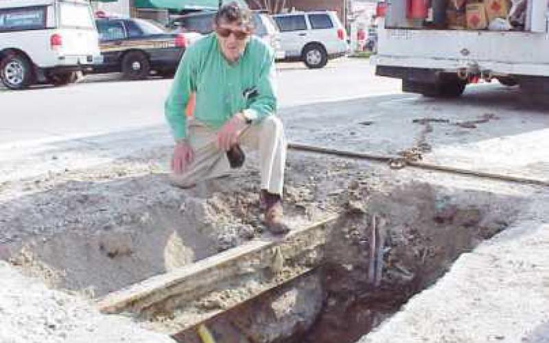 Stan Rossbach checks interurban track under Louisiana Avenue, 2003.