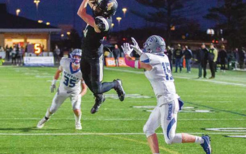 Surrounded by Generals, wide receiver Iain Hall makes a leaping catch.