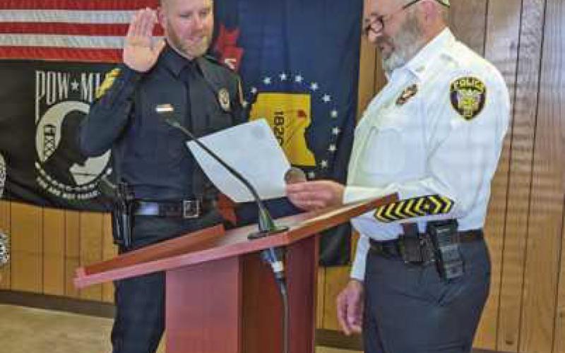 Sergeant Dustin Glass is administered the oath of office by Police Chief Mark Hetrick.