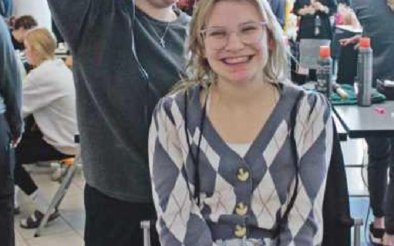 Sarah Modlin has her hair done by Brooklyn Mabry, a Perrysburg High School senior enrolled in cosmetology.