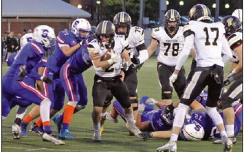 Quarterback T.J. Takats breaks through a hole up the center.