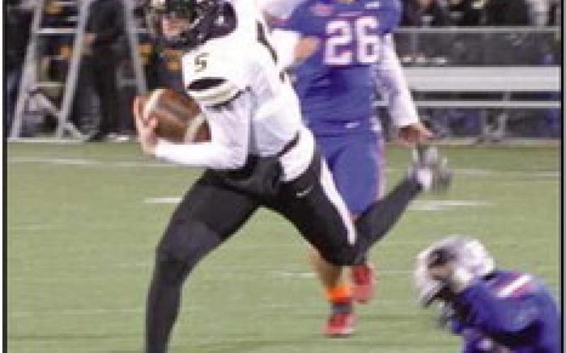 Runningback Conner Walendzak eludes tackle.