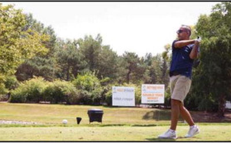 Jameel Burkett, president and CEO of Burkett Restaurant Equipment &amp;amp; Supplies, tees off.