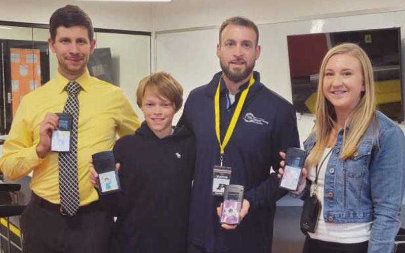 From left: Josh Roach, sixth-grade math teacher; Connor Bolles, sixth grader; Corey Bolles, owner of Bolles Professional Painting; and Genna Zachrich, sixth-grade math teacher.