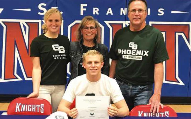 John Burnard with his sister Meghan, left, and parents Michelle and Jim during the signing ceremony at St. Francis High School.