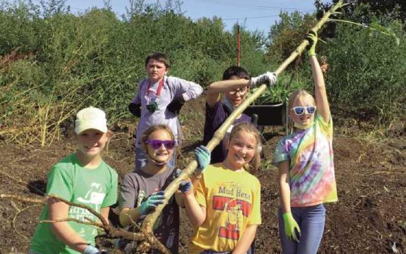 St. Rose sixth graders help out with service project at Toledo Grows