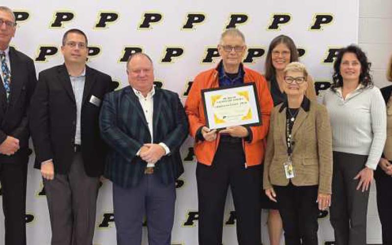 From left: Treasurer Randy Drewyor, board member Chris Anderson, Board Vice President Eric Benington, Dr. Chris Vogel, Board President Susan Rowland Miller, Superintendent Dr. Kadee Anstadt, board member Laura Meinke and board member Larimer.