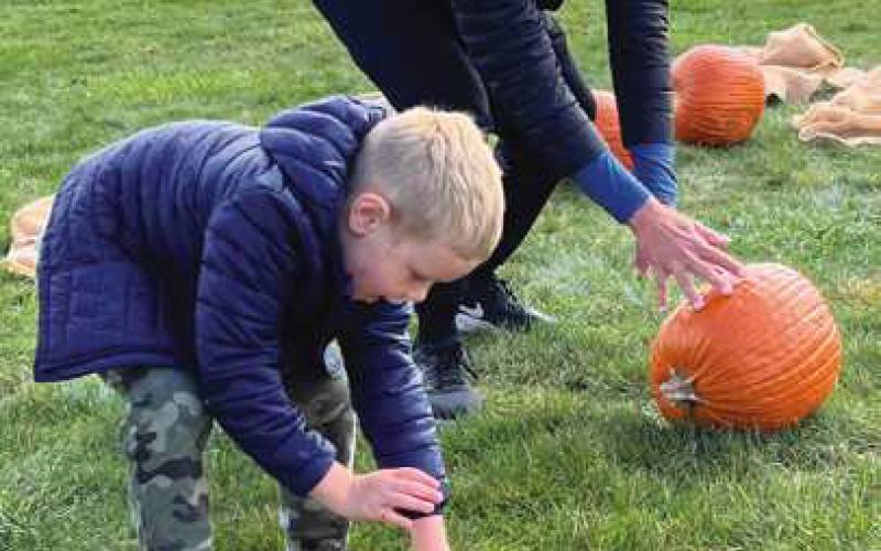 Perrysburg resident Logan Konieczny challenges his father, Eric, in a pumpkin race at the event.