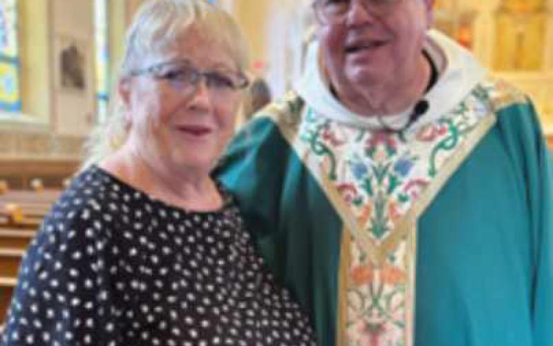 Sharon Hess and Monsignor Charles Singler, pastor of St. Rose.