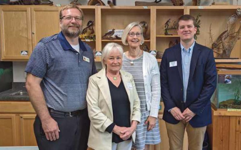 From left are Chris Smalley, park district director; Jeanne Lesniewicz of the Country Garden Club; Judy Lang, club president, and Tim Ansted, director of the Perrysburg Area Chamber of Commerce.