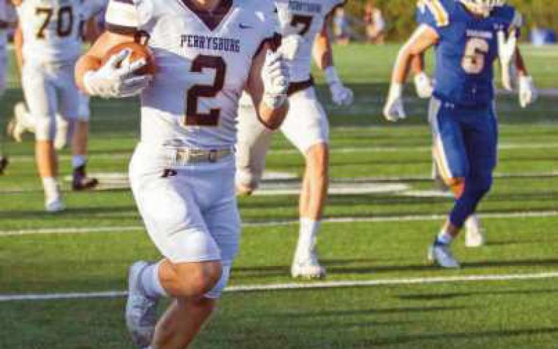 Runningback Connor Walendzak, eludes Trojan players, scooting down the sideline for six.