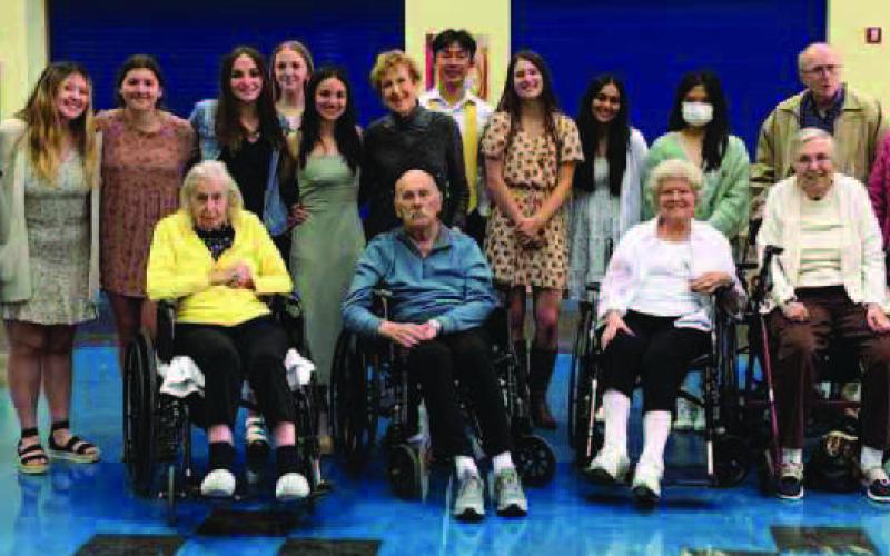 Guests enjoy dinner and dancing with Perrysburg High School students at a previous Senior Citizen Prom.