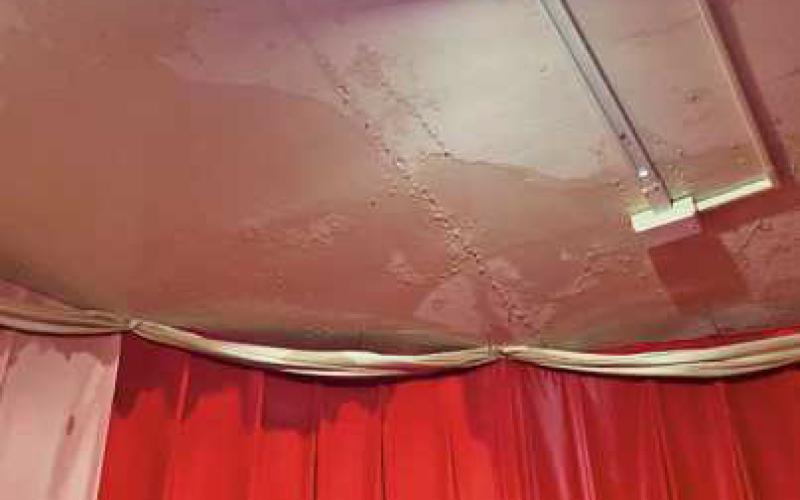Water can be seen seeping through the ceiling.