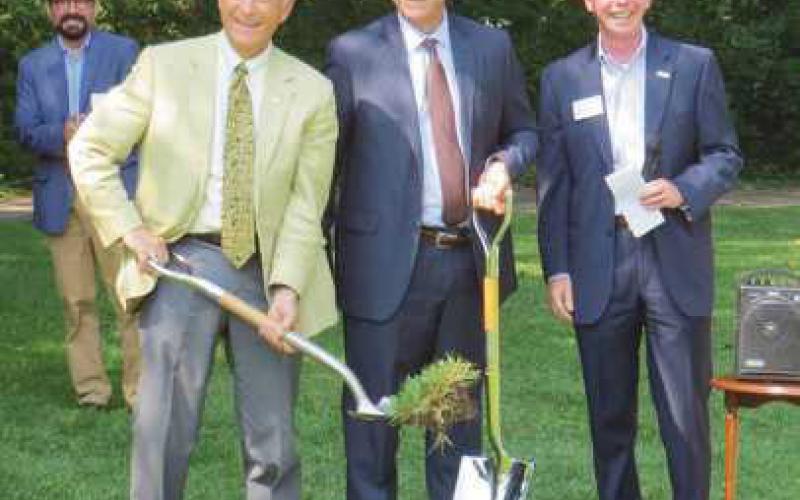 Chuck Stocking, left, donor advisor for an anonymous fund at the Greater Toledo Community Foundation, and Frank Bloomquist, vice president for Medical Mutual, Western Ohio, break ground for the new Environment Pocket Park, as foundation executive director Mike George, back, looks on with Genacross President/CEO Rick Marshall, far right.