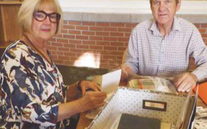Sarah (Snuggs) McConnell and Richard Baranowski look through photographs and letters.
