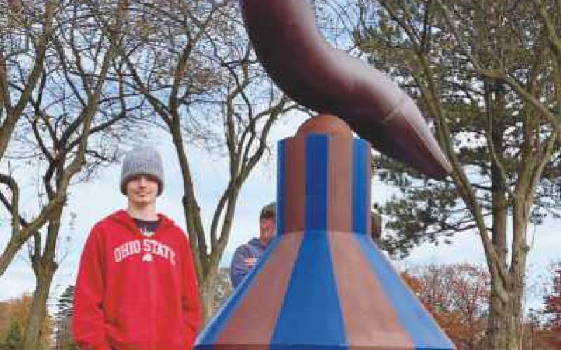 Artist Mike Sohikian donated the base of his sculpture, “Balance 1,” for a student design contest. Penta student Erik Baker, standing with the artwork, designed the winning entry.