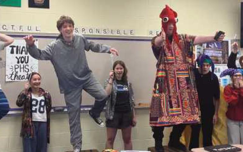 Students demonstrate the space scene from their play.