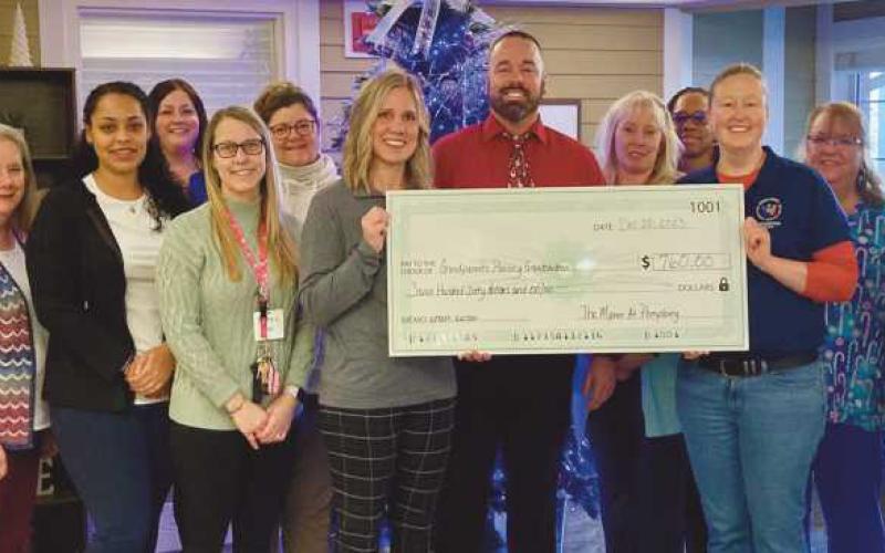 The Manor at Perrysburg, 250 Manor Drive, recently held a silent wreath auction and gala at the end of November. The event raised $760 and benefitted a local program with Wood County Educational Service Center–Grandparents Raising Grandchildren program. Pictured holding the check are Sarah and Angie from WCESC and the leadership team from the Manor at Perrysburg.
