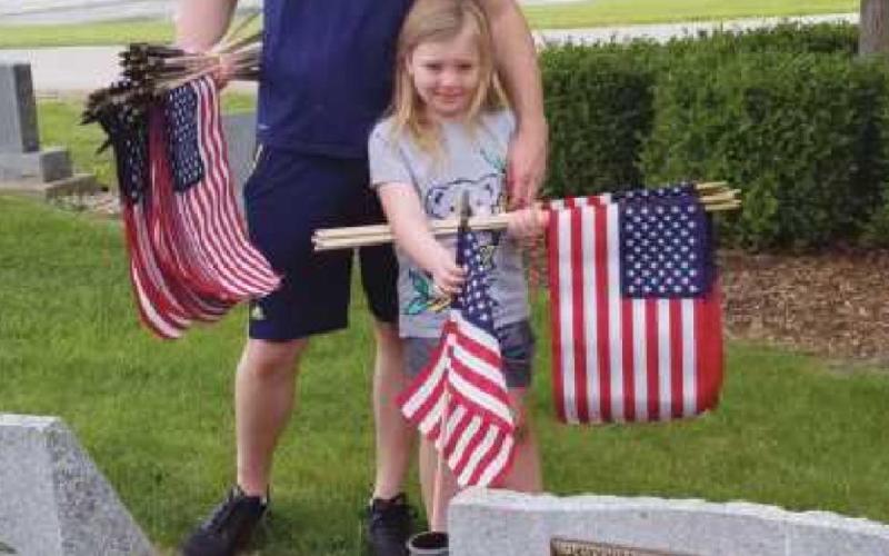 Alivia Zollars attends Memorial Day flag installation ceremony with her dad