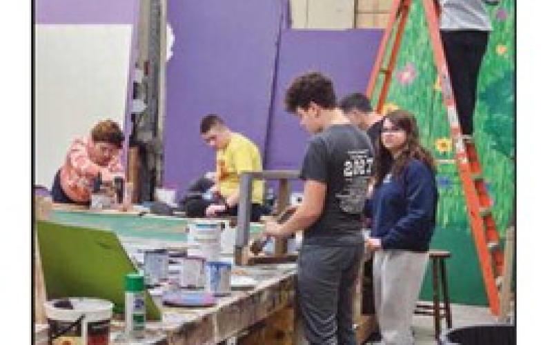 The set and props crew prepares for the show.