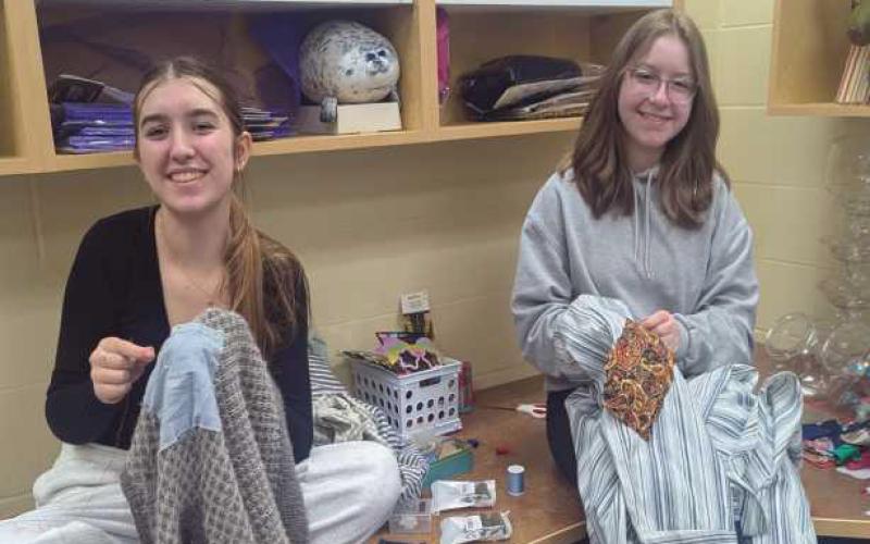 Alyssa King and Avery Bierschbach work on costumes.
