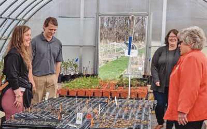 Park board members and visitors tour the greenhouse at J.C. Reuthinger Memorial Preserve to learn more about the cultivation of native plants and woodlands species grown by the stewardship department.