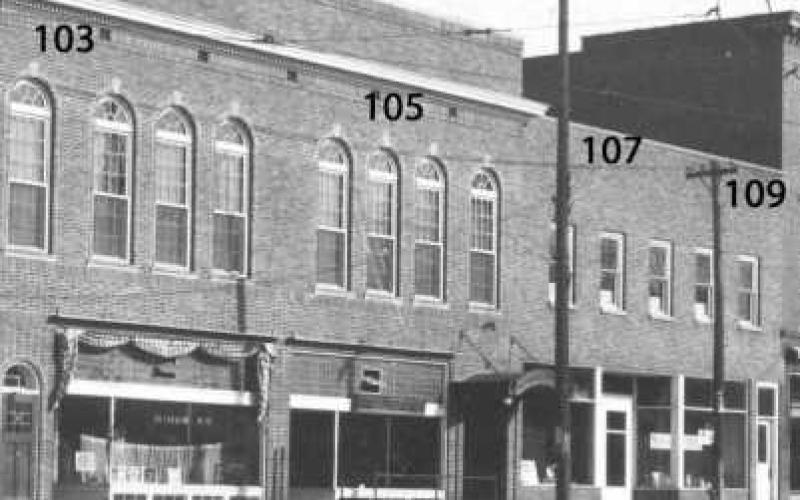 Many changes took place by the 1920s. That is a brick facade across 103-105.