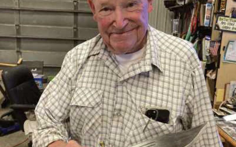 Doug Pratt with a knife salvaged from the plane cockpit.