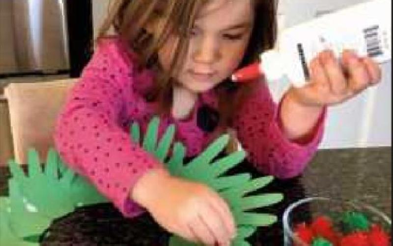 Make a festive wreath from a child’s traced hand