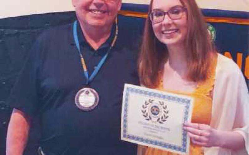 Bill Dupke, second vice president of the club, with May Exchange Club student of the month, Taylor Schwegler.