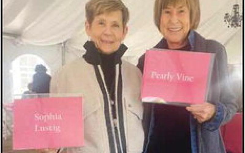Connie Murphy, left, and Cindy Rimmelin model clothing from two of the trunk show vendors, Sophia Lustig and Pearly Vine.