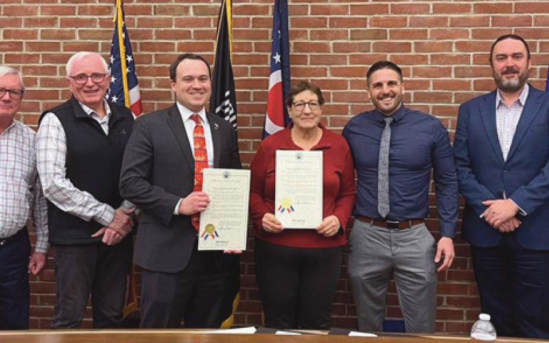 Perrysburg city council and Mayor Tom Mackin recognized outgoing council members, center left and right, for their service to the city .