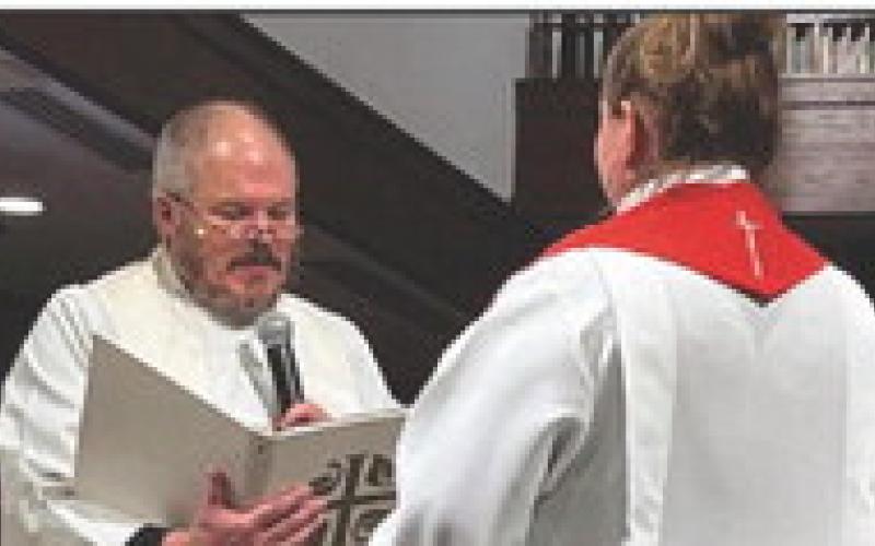 Rev. Paul Reichert, senior pastor of Zoar, participates in the ordination ceremony for the new associate pastor.
