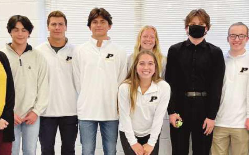 Swim and dive team state qualifiers are congratulated by board member Ray Pohlman.