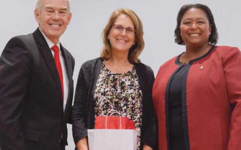 Ohio Department of Higher Education Chancellor Randy Gardner, left, and Owens President Dione Somerville, right, present the Presidential Teaching Award to Owens nursing professor Julie Lohse, center.