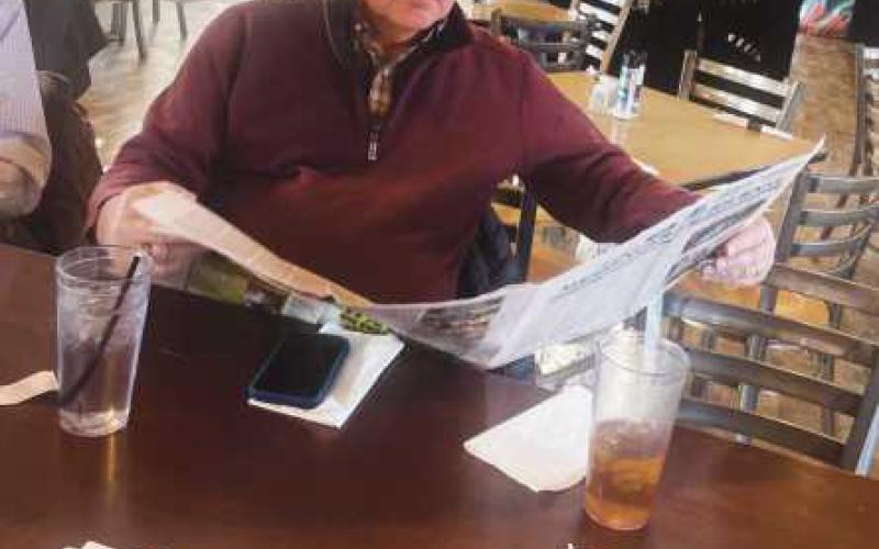 Perrysburg Township Trustee Bob Mack catches up on his reading at February’s Coffee with the Paper.