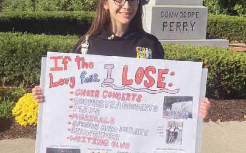 Rally organizer Delilah with her sign