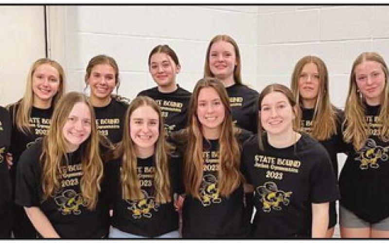 Perrysburg School Board member Kelly Ewbank with some of the PHS Jacket gymnasts who qualified for state competition this winter.
