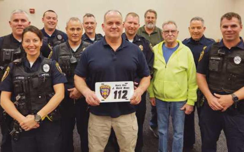 From left: Patrol Officer Chris Klewer, Patrol Officer Alicia Cryan, Patrol Officer Nick Owens, Sargeant Scott Mezinger, Lieutenant Dave Molter, retiring Deputy Chief Dave Nixon, Chief Matt Gazarek, Administrator Jon Eckel, Trustee Gary Britten, Lieutenant Jason Gladney and Patrol Officer Ryan Welch.