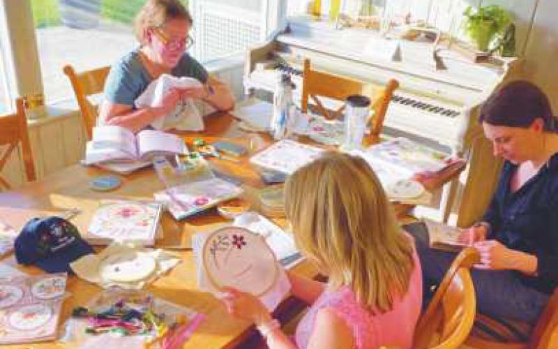Students participate in an embroidery class.