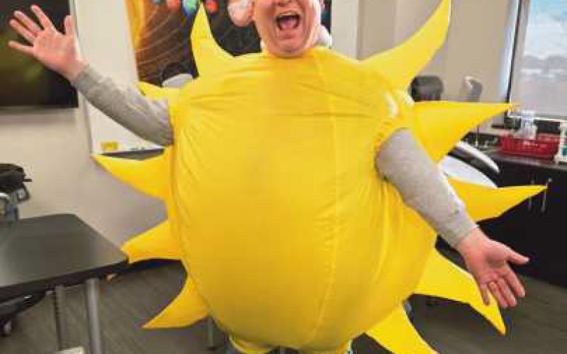 Jason Jordan assisting in a science lesson at HPI by dressing as the sun.