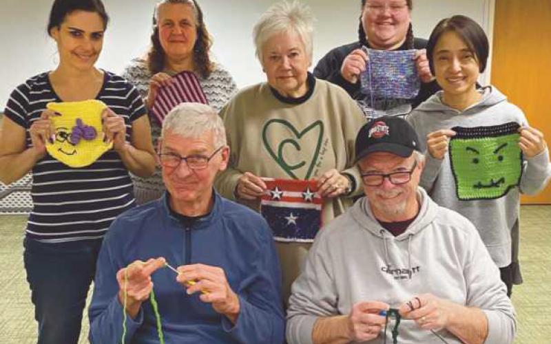 Participants in the America 250 Ohio: knit and crochet class show their submissions for the Framework of America Community Fiber Arts Mural.