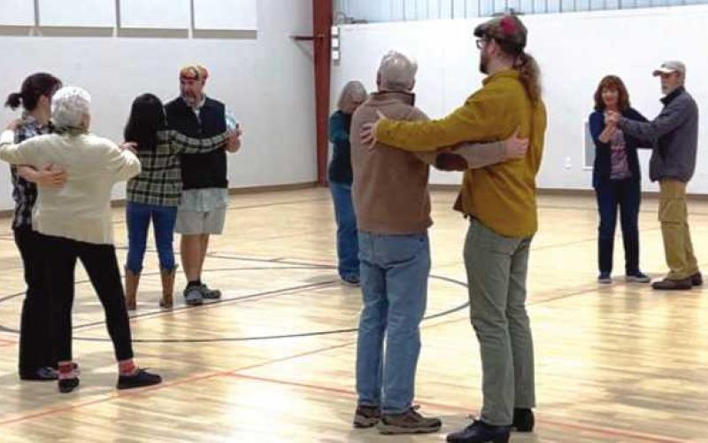 Couples enjoying the community contra dance.