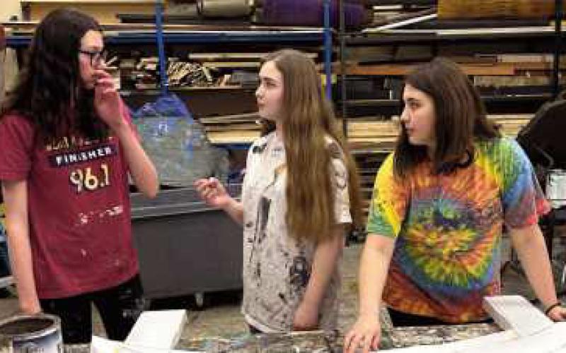 Members of the set design crew, hard at work.