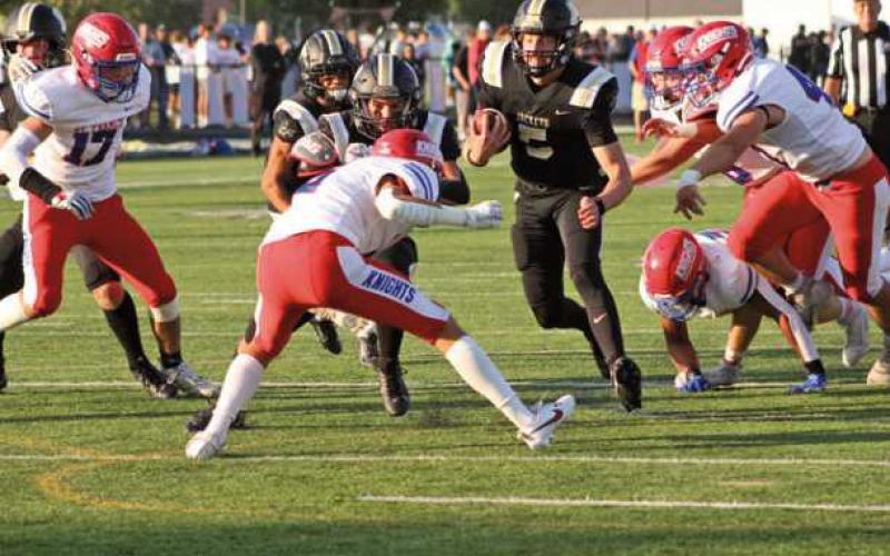 Quarterback Josh Takats breaks through the initial line before bulldozing through for the touchdown in the first quarter.