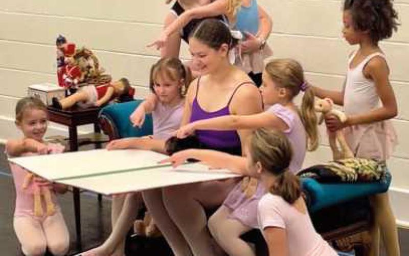 The Nanny, performed by Bryn Rajner, reads a book to young dancers and Clara in the opening scene of the show.