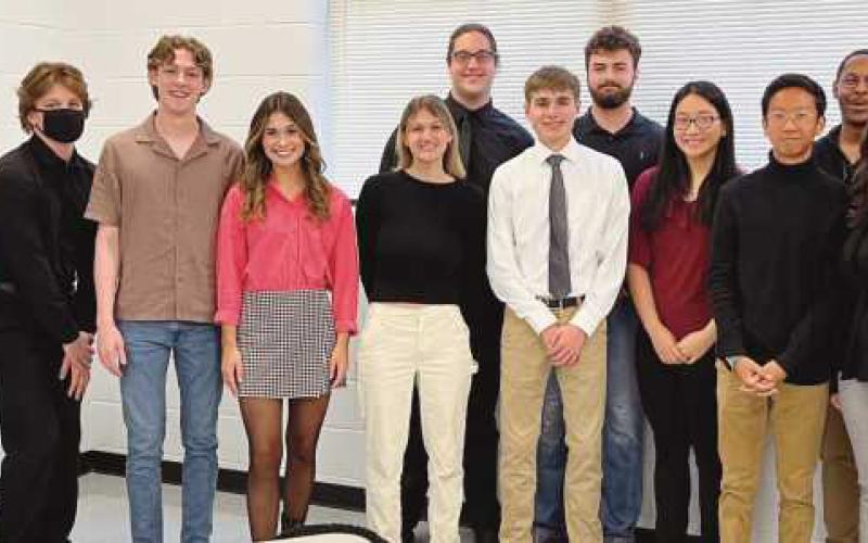 Board member Dr. Lori Reffert congratulates the Perrysburg musicians who qualified for OMEA competition.