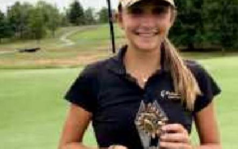 Sydney Deal holds the trophy at Shelby Country Club.